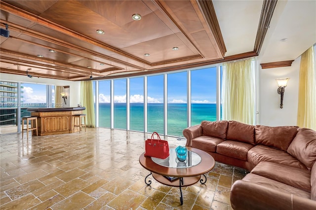 living room featuring floor to ceiling windows, a water view, and ornamental molding