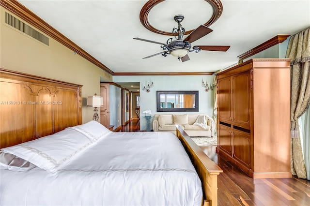 bedroom with crown molding, visible vents, dark wood-style flooring, and ceiling fan