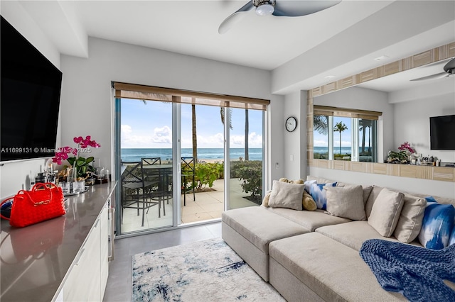 living room with ceiling fan and concrete flooring