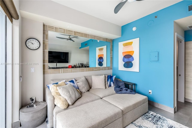 living room with ceiling fan and concrete floors