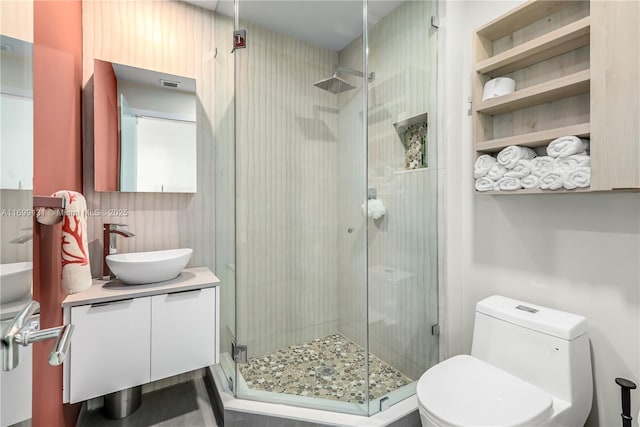 full bath with vanity, toilet, and a shower stall