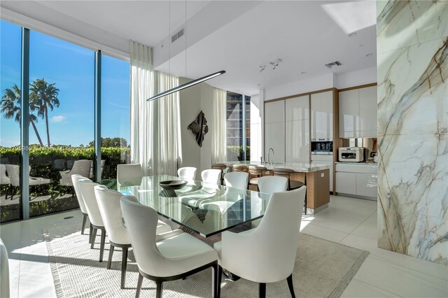 dining area featuring light tile patterned flooring