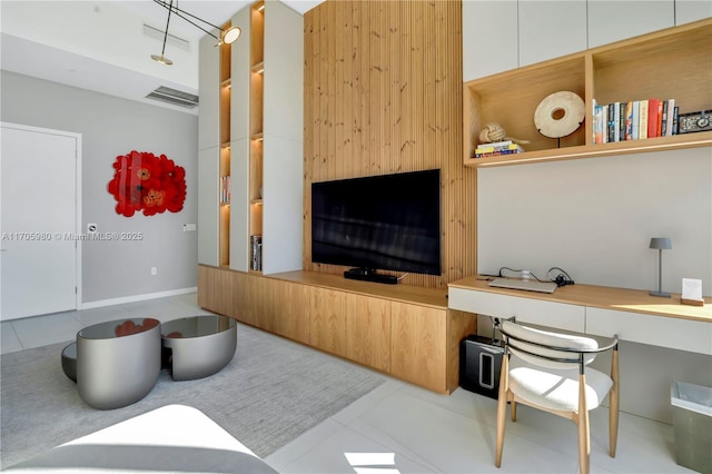 living room featuring light tile patterned floors and built in desk