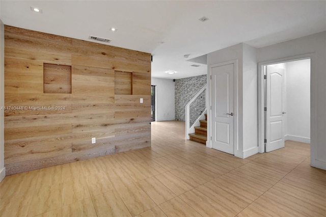 spare room with wooden walls