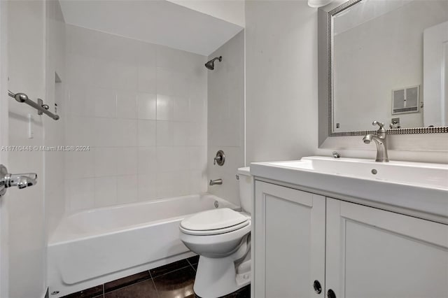 full bathroom with tile patterned floors, vanity, tiled shower / bath combo, and toilet