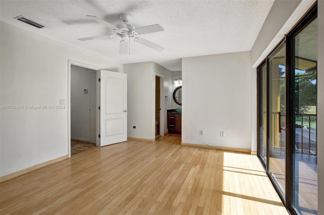 unfurnished room with a textured ceiling, light hardwood / wood-style flooring, and ceiling fan