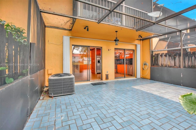 view of patio with a lanai and central AC unit