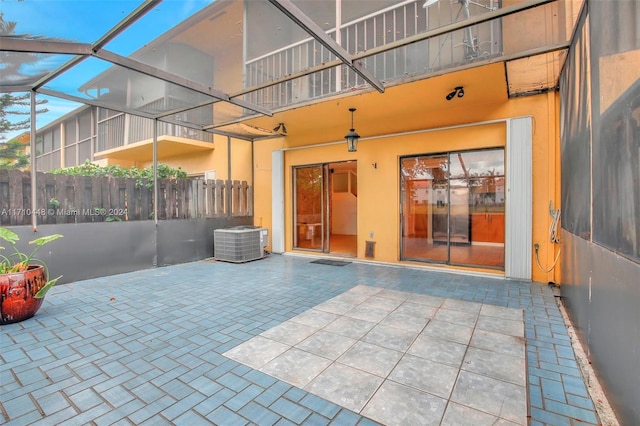 view of patio / terrace with a lanai and central AC unit