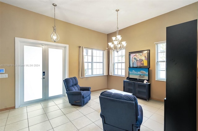 tiled living room with french doors, plenty of natural light, and a notable chandelier