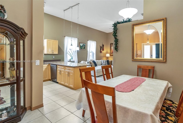 dining space featuring light tile patterned floors and rail lighting