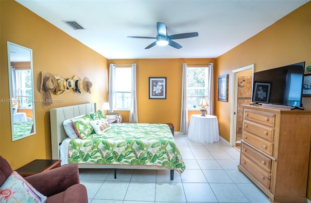 bedroom with multiple windows, ceiling fan, and light tile patterned flooring