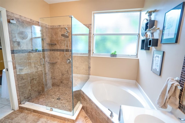 bathroom with tile patterned floors and shower with separate bathtub