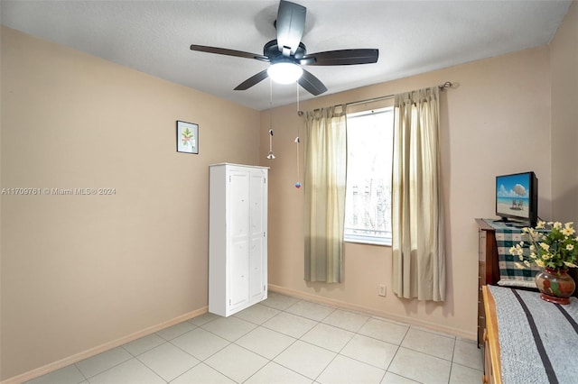 unfurnished bedroom with ceiling fan and a textured ceiling