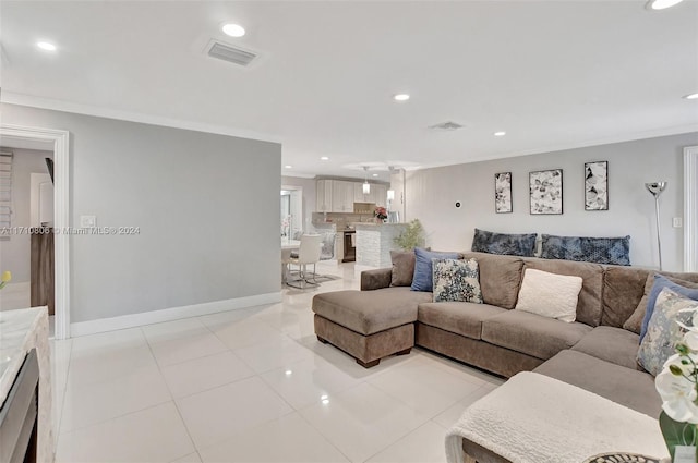 living room featuring crown molding and light tile patterned floors