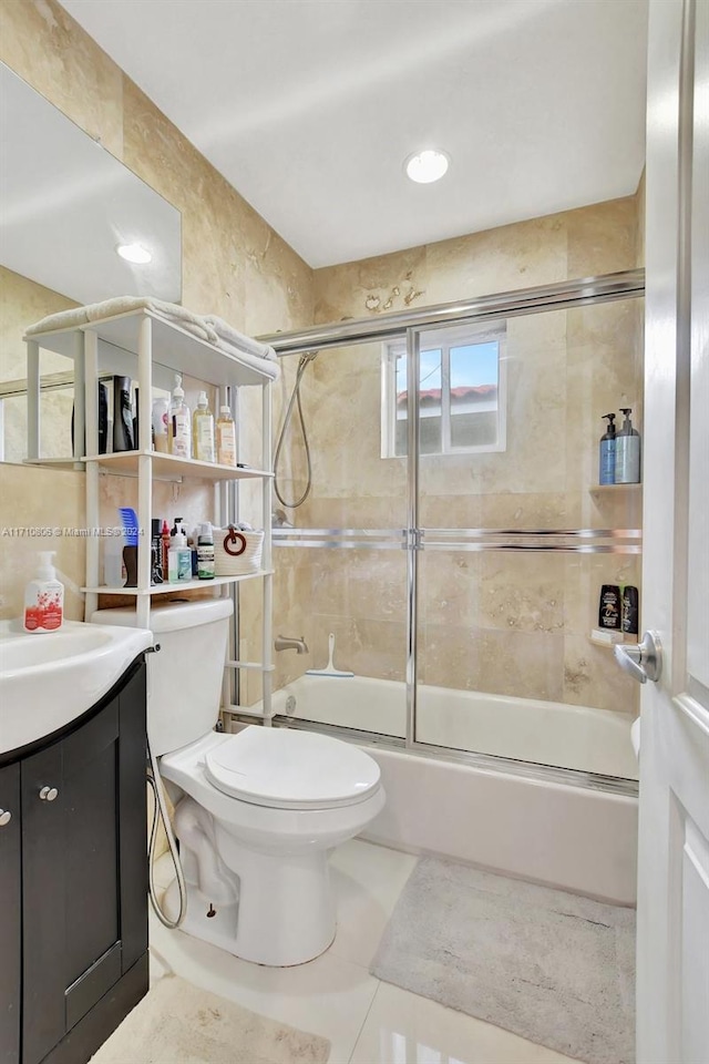 full bathroom featuring tile patterned floors, vanity, toilet, and enclosed tub / shower combo