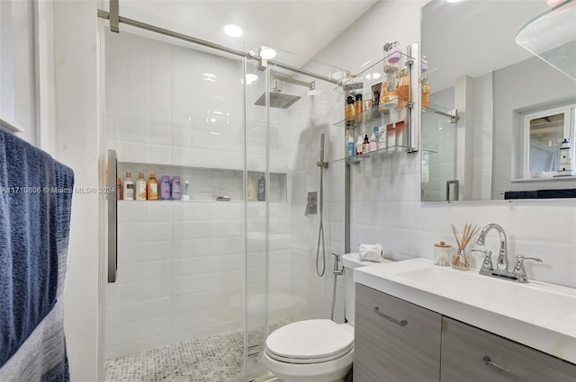 bathroom with vanity, backsplash, toilet, tile walls, and an enclosed shower