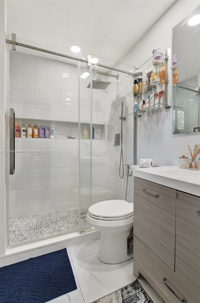 bathroom with walk in shower, vanity, and toilet