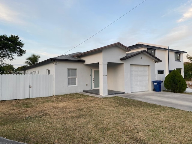 view of front of property with a front yard and a garage