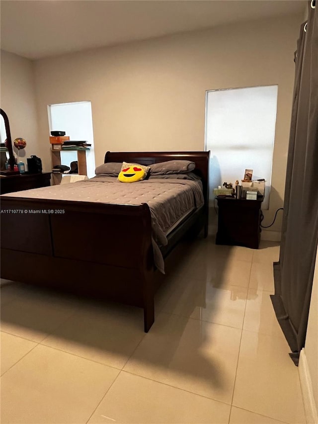 bedroom with light tile patterned floors