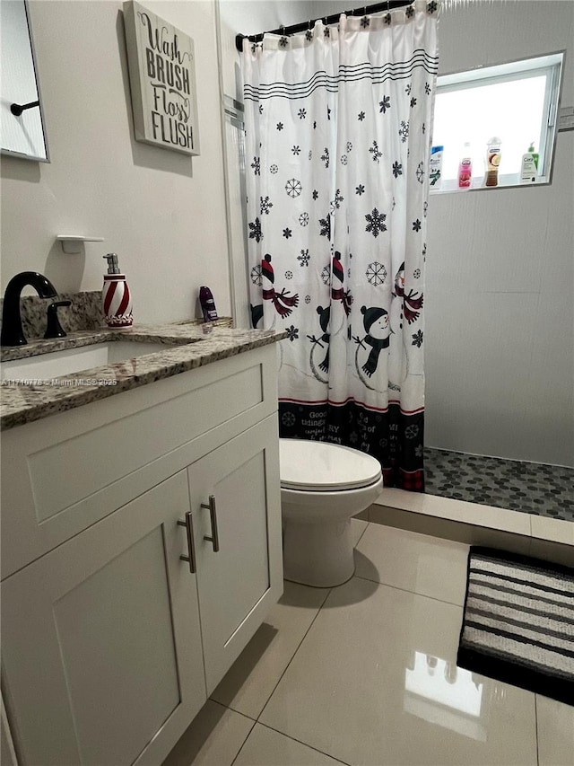 bathroom featuring tile patterned flooring, vanity, toilet, and a shower with shower curtain