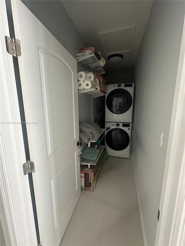 laundry room with stacked washer / dryer