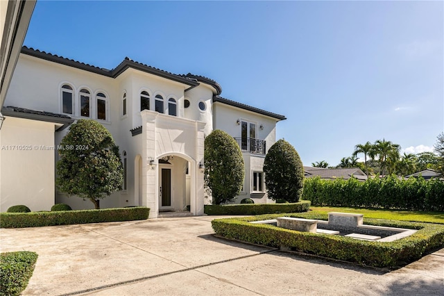 mediterranean / spanish home with a balcony