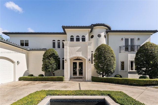 mediterranean / spanish-style house featuring french doors and a balcony