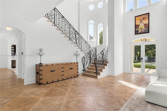 entryway featuring a high ceiling and parquet floors