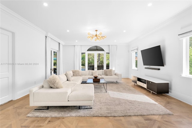 living room featuring a chandelier, ornamental molding, and light parquet flooring