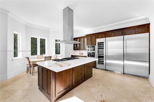 kitchen featuring island range hood, crown molding, and appliances with stainless steel finishes