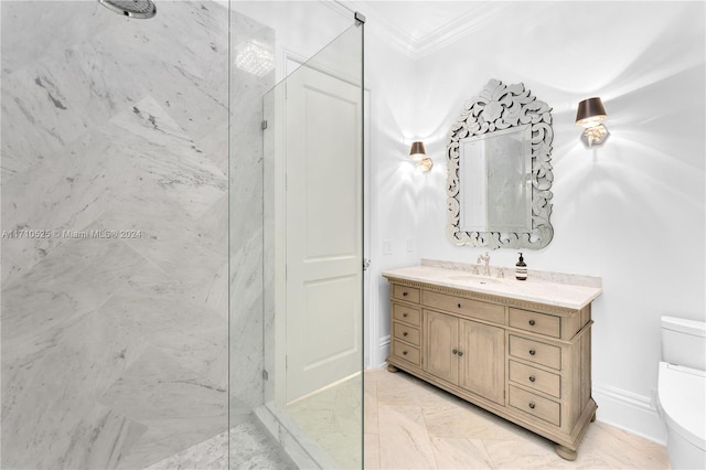 bathroom featuring vanity, toilet, ornamental molding, and a tile shower