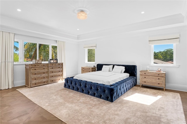 bedroom featuring multiple windows, crown molding, and light parquet flooring