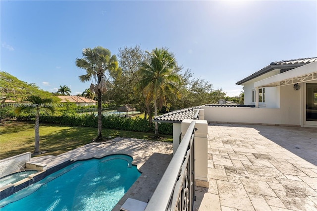 view of pool with a patio area and a lawn