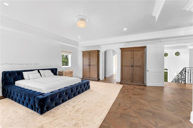 bedroom with dark parquet floors and ornamental molding