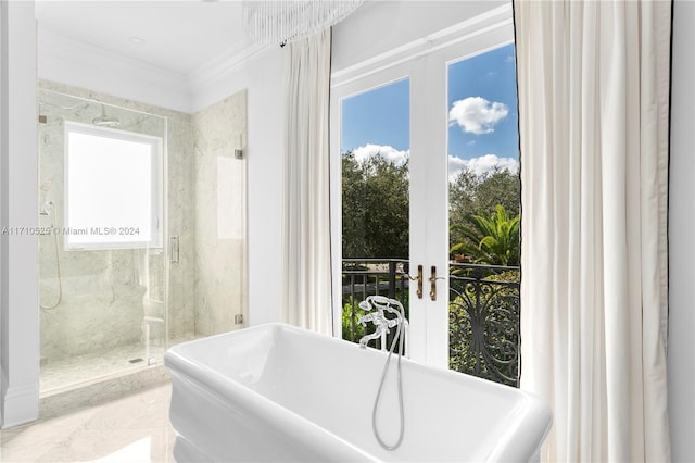 bathroom featuring plenty of natural light, plus walk in shower, and french doors