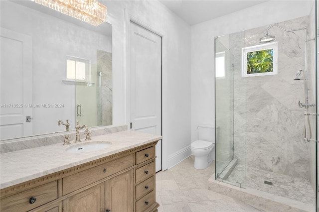 bathroom featuring vanity, an enclosed shower, and toilet