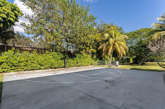 view of basketball court featuring a yard