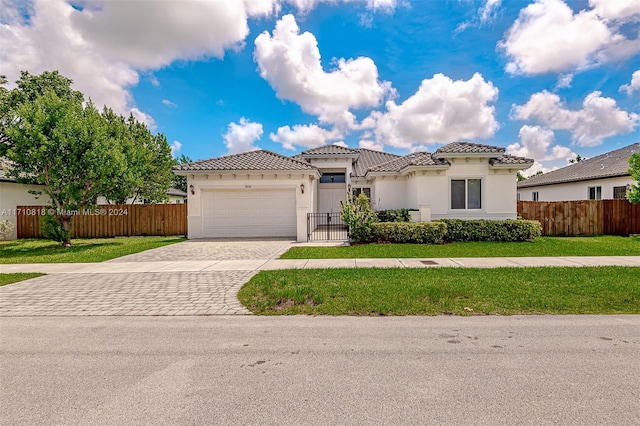 9334 SW 173rd Ter, Palmetto Bay, FL 33157 - mediterranean / spanish-style home featuring a front lawn and a garage