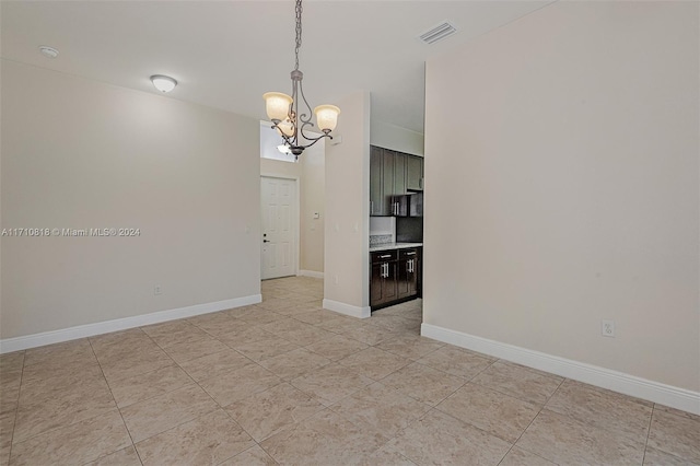 spare room with a chandelier