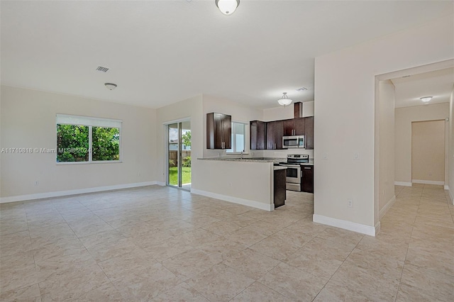 kitchen with dark brown cabinets and appliances with stainless steel finishes