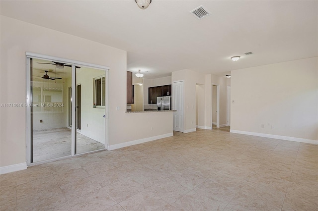 unfurnished living room with ceiling fan