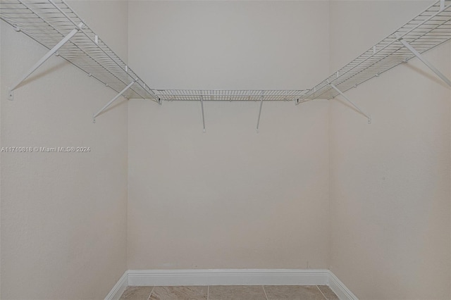 spacious closet featuring tile patterned flooring