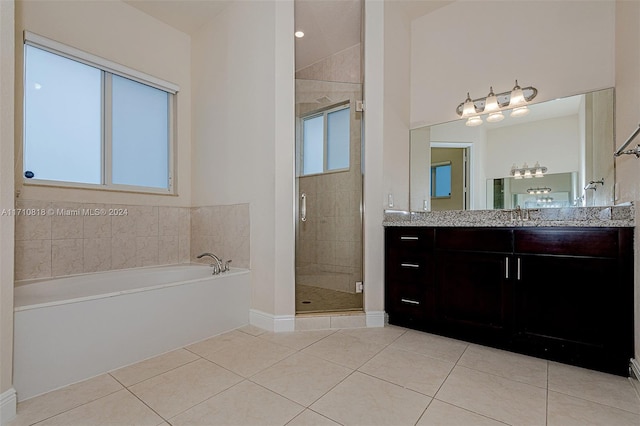 bathroom featuring vanity, tile patterned flooring, and plus walk in shower