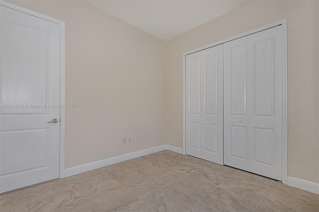 unfurnished bedroom featuring a closet