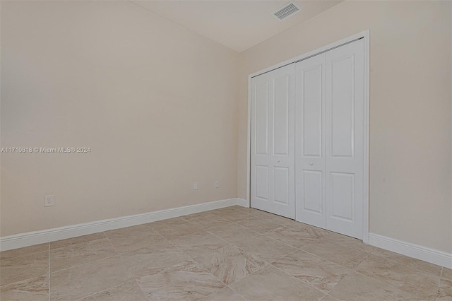 unfurnished bedroom with a closet