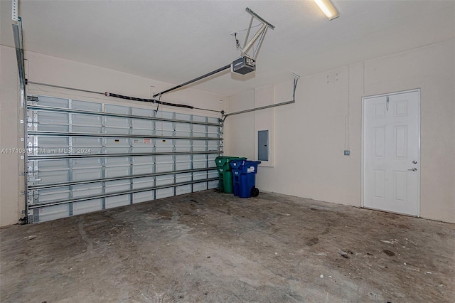 garage featuring electric panel and a garage door opener