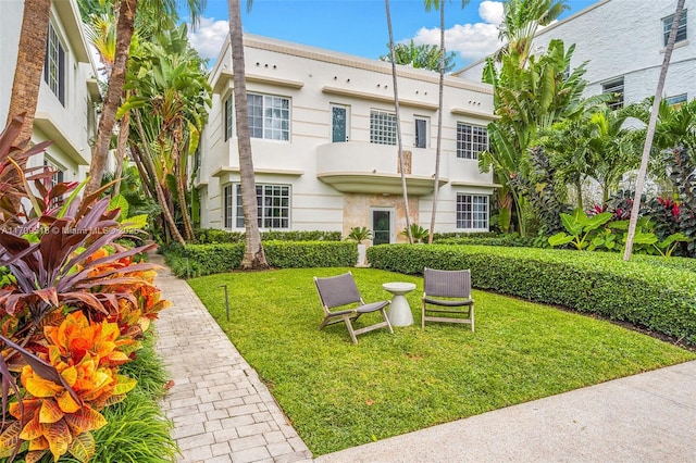 back of house featuring a yard