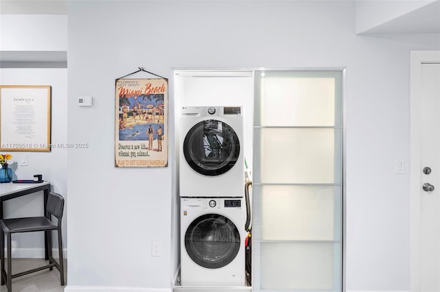 laundry room featuring stacked washer and dryer