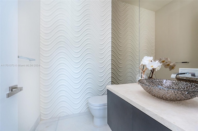 bathroom featuring tile patterned flooring, vanity, and toilet