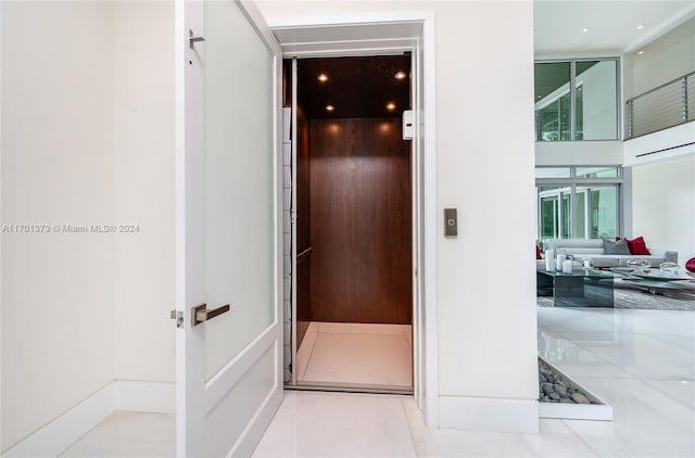 interior space featuring elevator and light tile patterned floors